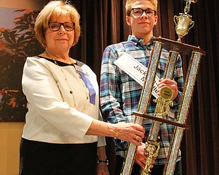      ROBERT K. YOSAY  | THE VINDICATOR.. Mary Kay Earnhardt.. and the first place trophy to Ryan Staton from Jackson Miltmon Middle School and ..THE VINDICATOR 83rd Regional Spelling Bee  at YSU Kilcawley Room...--30-...