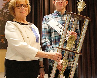      ROBERT K. YOSAY  | THE VINDICATOR.. Mary Kay Earnhardt.. and the first place trophy to Ryan Staton from Jackson Miltmon Middle School and ..THE VINDICATOR 83rd Regional Spelling Bee  at YSU Kilcawley Room...--30-...