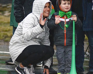 Katie Rickman | The Vindicator.Cayden Gordon 3 of Lowellville stands next to his aunt Laurin Paulin of Boardman as they wave to participants of the St. Patricks Day Parade in Boardman on Sunday afternoon.