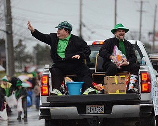 Katie Rickman | The Vindicator.Mahoning County Commissioners Anthony Traficanti, left, and David Ditzler throw candy to parade goers along Rt. 224 during the St. Patricks Day Parade in Boardman on Sunday afternoon.