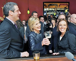 Jeff Lange | The Vindicator  SAT, MAR 12, 2016 - Democratic presidential candidate Hillary Clinton enjoys a beer at O'Donald's Irish Pub & Grill in downtown Youngstown after speaking at a campaign rally Saturday night. Joining Clinton at the bar was U.S. Rep Tim Ryan and his wife, Andrea.