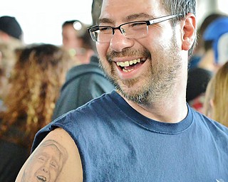 Jeff Lange | The Vindicator  MON, MAR 14, 2016 - Anthony Bordell of Warren laughs as he shows fellow Trump supporters his tattoo of the Donald on his upper arm before the start of Republican presidential candidate Donald Trump's campaign rally in Vienna Monday night.
