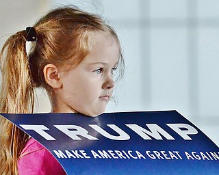 Jeff Lange | The Vindicator  MON, MAR 14, 2016 - Five-year-old Zoey Mitchell of Columbiana County holds a Trump sign before the start of the Donald Trump rally in Vienna Monday night.