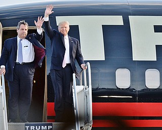 Jeff Lange | The Vindicator  MON, MAR 14, 2016 - New Jersey Governor Chris Christie and Republican presidential candidate Donald Trump wave as they step out of Trumps jet prior to the start of Trump's campaign rally in Vienna Monday night.