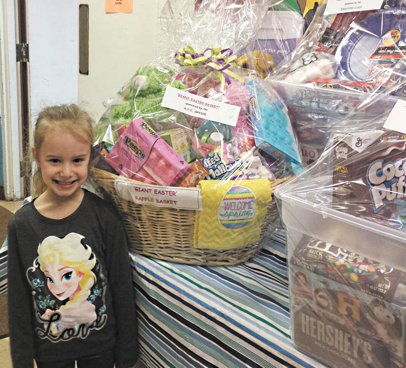 SPECIAL TO THE VINDICATOR | Austintown Community Church Preschool Childcare Center student Clara Eckonen shows off a variety of raffle basket items that will be available at the center’s 2016 Trash and Treasure Sale from 9 a.m. to 1 p.m. Saturday in the youth auditorium of the education wing at the church, 242 S. Canfield-Niles Road. Drawings for the raffle baskets are set for 12:45 p.m.; winners do not need to be present. Snacks, lunch items and beverages will be available for purchase. Proceeds from the sale will help purchase developmentally appropriate resources for the students of the school. Call the school during business hours at 330-793-1843 or visit www.yourACC.org for information. The Austintown Kiwanis Club will host a pancake breakfast from 8 a.m. to 1 p.m. at the church the same day. Tickets are available from Kiwanis members and at the door. All breakfast proceeds benefit the youth of Austintown.