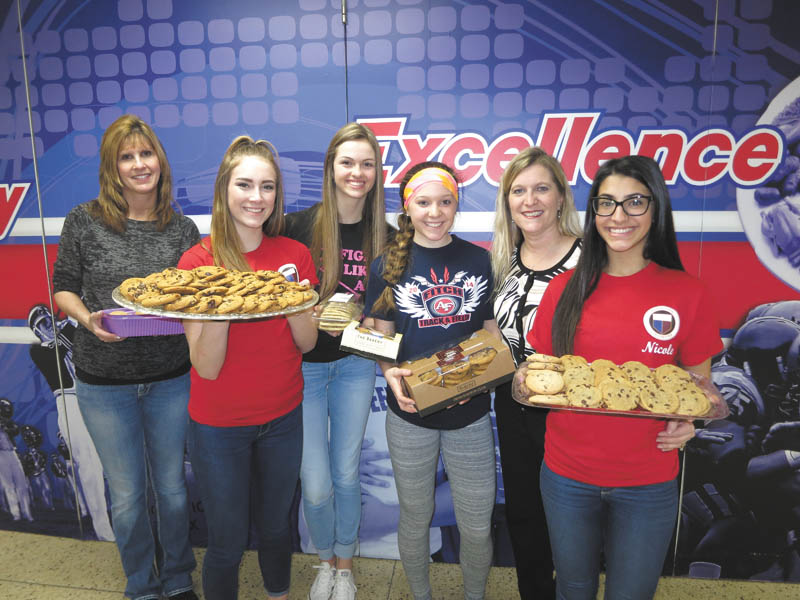 SPECIAL TO THE VINDICATOR | The GFWC Ohio Austintown Junior Women’s League Juniorettes provided cookies for the eighth annual Souper Supper at Austintown Fitch High School, an event organized in cooperation with the Austintown Council of PTAs and the Fitch art department. The event included a meal, music by Fitch band students and a basket raffle. Handcrafted bowls from Fitch art students were sold during the event. Proceeds benefited needy families in the Austintown school district. Sharing cookies and smiles at the event were, from left, Juniorette adviser Kelly Constance, Erin Duffy, Gina DiFrancesco, Kayla Sahli, adviser Kerri Sahli and Nichole Noday. For information on the AJWL, visit www.facebook.com/AJWL2014.