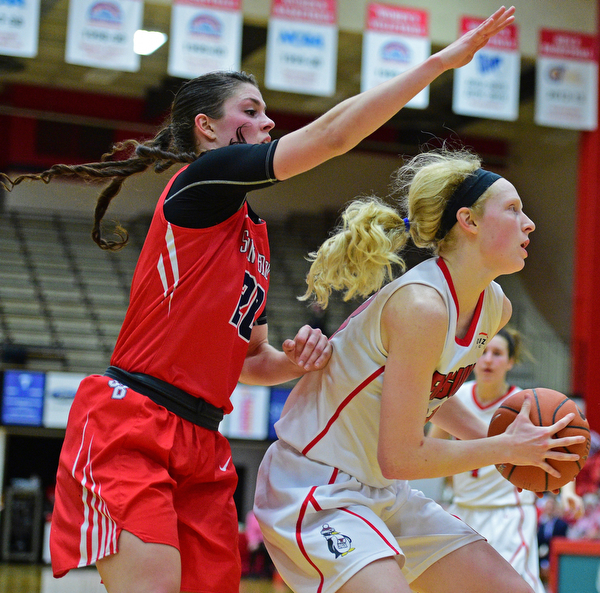 YOUNGSTOWN, OHIO - MARCH 16, 2016: Sarah Cash #23 of YSU plays the ball while Brittany Snow #20 of Stoney Brook waits to attempt to block the shot over her back during their 2nd half of their game Wednesday night at Beeghly Center. DAVID DERMER | THE VINDICATOR
