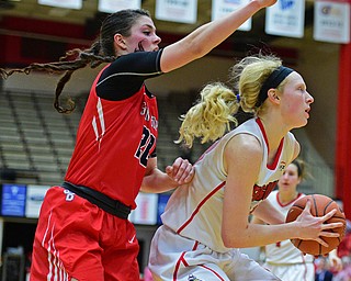 YOUNGSTOWN, OHIO - MARCH 16, 2016: Sarah Cash #23 of YSU plays the ball while Brittany Snow #20 of Stoney Brook waits to attempt to block the shot over her back during their 2nd half of their game Wednesday night at Beeghly Center. DAVID DERMER | THE VINDICATOR