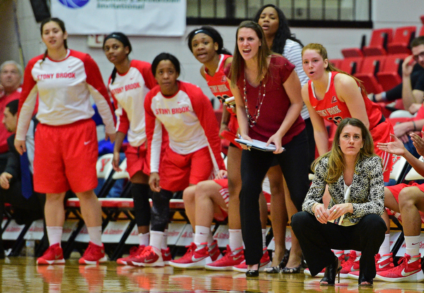 YOUNGSTOWN, OHIO - MARCH 16, 2016: Head coach Caroline McCombs of Stoney Brook and the rest of the bench watch the action from the sideline during their 2nd half of their game Wednesday night at Beeghly Center. DAVID DERMER | THE VINDICATOR
