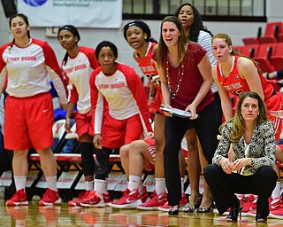 YOUNGSTOWN, OHIO - MARCH 16, 2016: Head coach Caroline McCombs of Stoney Brook and the rest of the bench watch the action from the sideline during their 2nd half of their game Wednesday night at Beeghly Center. DAVID DERMER | THE VINDICATOR