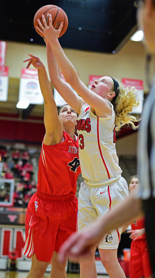 YOUNGSTOWN, OHIO - MARCH 16, 2016: Sarah Cash #23 of YSU leaps to play the high pass over the arms of Alyssa Coiro #40 of Stoney Brook during their 2nd half of their game Wednesday night at Beeghly Center. DAVID DERMER | THE VINDICATOR