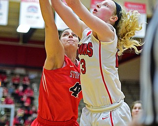 YOUNGSTOWN, OHIO - MARCH 16, 2016: Sarah Cash #23 of YSU leaps to play the high pass over the arms of Alyssa Coiro #40 of Stoney Brook during their 2nd half of their game Wednesday night at Beeghly Center. DAVID DERMER | THE VINDICATOR