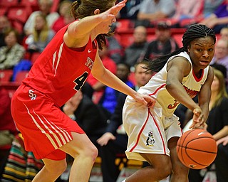 YOUNGSTOWN, OHIO - MARCH 16, 2016: Indiya Benjamin #3 of YSU passes the ball around Christa Scognamiglio #4 of Stoney Brook during their 2nd half of their game Wednesday night at Beeghly Center. DAVID DERMER | THE VINDICATOR