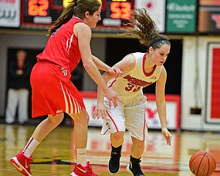 YOUNGSTOWN, OHIO - MARCH 16, 2016: Jenna Hirsch #32 of YSU loses control of the ball while being pressured by Christa Scognamiglio #4 of Stoney Brook during their 2nd half of their game Wednesday night at Beeghly Center. DAVID DERMER | THE VINDICATOR