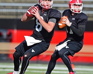 YOUNGSTOWN, OHIO - MARCH 18, 2016: Hunter Wells (left) and Trent Hosick (right) drop back to pass during a passing drill during the teams practice Friday afternoon at Stambaugh Stadium. DAVID DERMER | THE VINDICATOR