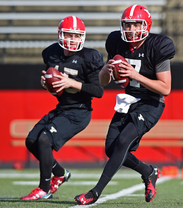 YOUNGSTOWN, OHIO - MARCH 18, 2016: Nathan Mays (right) and Jon Saadey (left) drop back to pass during a passing drill during the teams practice Friday afternoon at Stambaugh Stadium. DAVID DERMER | THE VINDICATOR