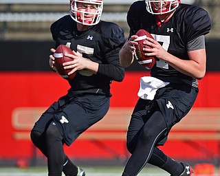 YOUNGSTOWN, OHIO - MARCH 18, 2016: Nathan Mays (right) and Jon Saadey (left) drop back to pass during a passing drill during the teams practice Friday afternoon at Stambaugh Stadium. DAVID DERMER | THE VINDICATOR