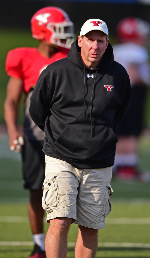 YOUNGSTOWN, OHIO - MARCH 18, 2016: Head coach Bo Pelini of YSU walks on the field in-between drills during the teams practice Friday afternoon at Stambaugh Stadium. DAVID DERMER | THE VINDICATOR