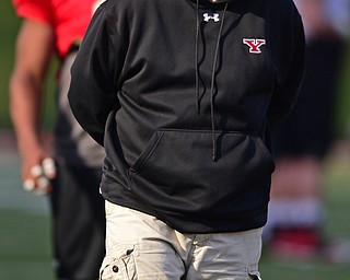 YOUNGSTOWN, OHIO - MARCH 18, 2016: Head coach Bo Pelini of YSU walks on the field in-between drills during the teams practice Friday afternoon at Stambaugh Stadium. DAVID DERMER | THE VINDICATOR