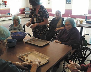 SPECIAL TO THE VINDICATOR
Residents at Parkside Health Care Center in Columbiana recently organized a Parkside Baking Club. Each Thursday during March and April, the club will host a bake sale to benefit Harvest for Hunger and the Second Harvest Food Bank. A group of bakers are shown here cooking and packaging some of the goods that they sell to staff, family members and visitors to the center. The club is also collecting nonperishable food during March and April to contribute to the project. Visit the center at 930 E. Park Ave. to donate.