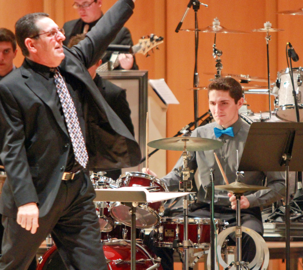 William d Lewis the vindiator  Boardman band direcotr Tom Ruggieri leads the Boardman HS Jazz Esemble 1 during a 3-19-16 concert at Powers Auditorium in youngstown. On drums is his son Nico, a senior at Boardman HS. they opened for the Buddy Rich Band.