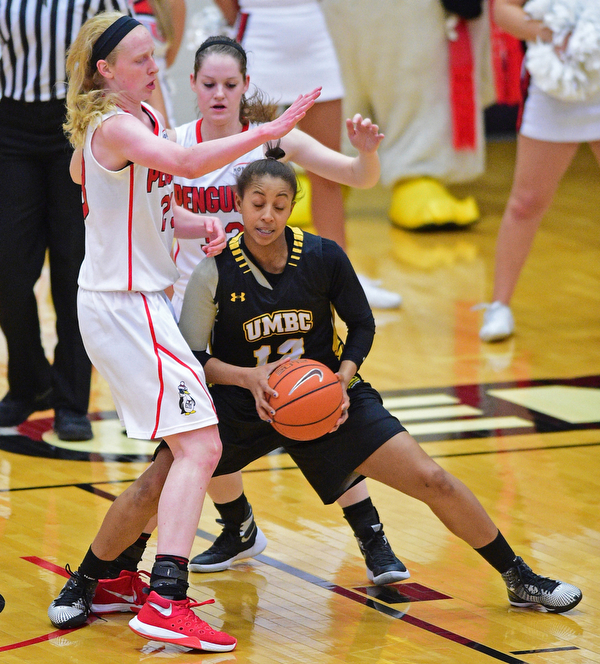 YOUNGSTOWN, OHIO - MARCH 19, 2016: Capree Garner #12 of UMBC travels with he basketball after running into Sarah Cash #23 and Jenna Hirsch #32 of YSU during the 1st half of their game Saturday afternoon at Beeghly Center. YSU won 67-48. DAVID DERMER | THE VINDICATOR