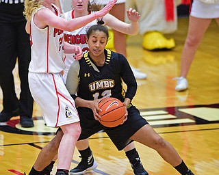 YOUNGSTOWN, OHIO - MARCH 19, 2016: Capree Garner #12 of UMBC travels with he basketball after running into Sarah Cash #23 and Jenna Hirsch #32 of YSU during the 1st half of their game Saturday afternoon at Beeghly Center. YSU won 67-48. DAVID DERMER | THE VINDICATOR