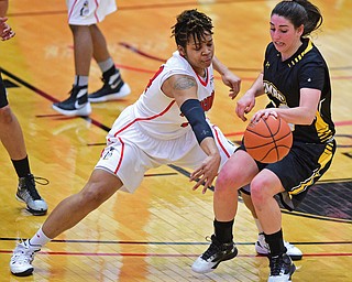 YOUNGSTOWN, OHIO - MARCH 19, 2016: Janae Jackson #44 of YSU swats at the basketball while Emily Russo #23 of UMBC guards against it during the 1st half of their game Saturday afternoon at Beeghly Center. YSU won 67-48. DAVID DERMER | THE VINDICATOR
