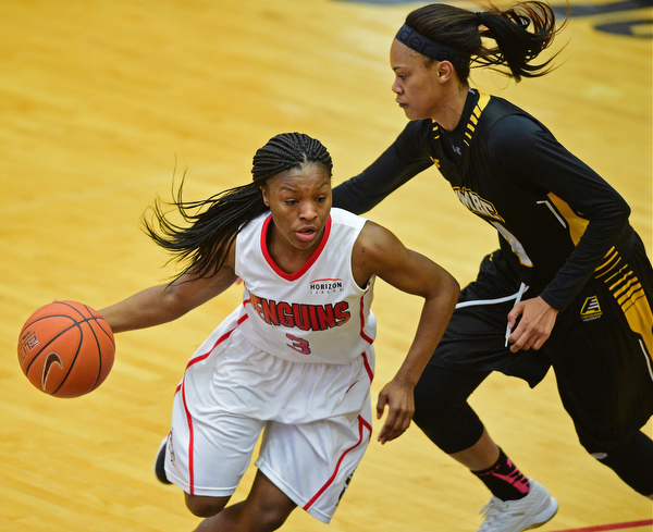 YOUNGSTOWN, OHIO - MARCH 19, 2016: Indiya Benjamin #3 of YSU drives to the basket while Taylor McCarley #4 of UMBC swipes at the basketball during the 1st half of their game Saturday afternoon at Beeghly Center. YSU won 67-48. DAVID DERMER | THE VINDICATOR
