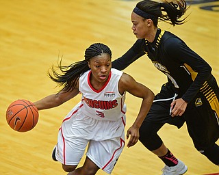 YOUNGSTOWN, OHIO - MARCH 19, 2016: Indiya Benjamin #3 of YSU drives to the basket while Taylor McCarley #4 of UMBC swipes at the basketball during the 1st half of their game Saturday afternoon at Beeghly Center. YSU won 67-48. DAVID DERMER | THE VINDICATOR