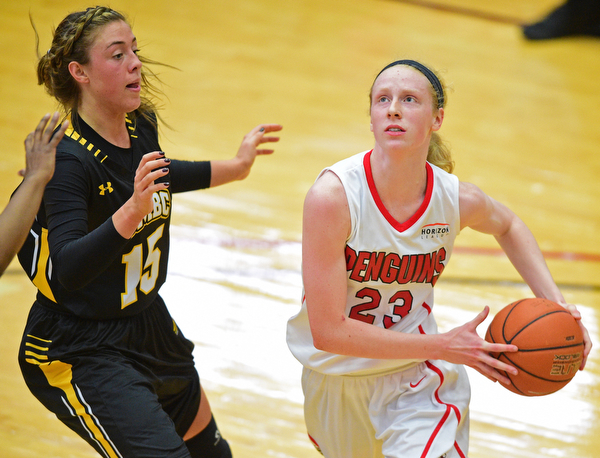 YOUNGSTOWN, OHIO - MARCH 19, 2016: Sarah Cash #23 of YSU looks to the basket Amanda Hagaman #15 of UMBC closes in to defend the basket during the 1st half of their game Saturday afternoon at Beeghly Center. YSU won 67-48. DAVID DERMER | THE VINDICATOR