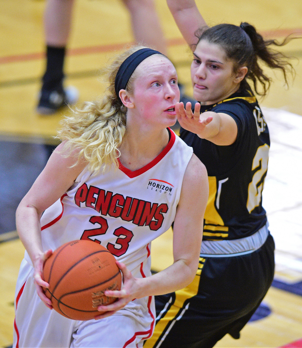 YOUNGSTOWN, OHIO - MARCH 19, 2016: Sarah Cash #23 of YSU goes to the basket while being guarded by Laura Cataldo #25 of UMBC during the 1st half of their game Saturday afternoon at Beeghly Center. YSU won 67-48. DAVID DERMER | THE VINDICATOR