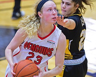 YOUNGSTOWN, OHIO - MARCH 19, 2016: Sarah Cash #23 of YSU goes to the basket while being guarded by Laura Cataldo #25 of UMBC during the 1st half of their game Saturday afternoon at Beeghly Center. YSU won 67-48. DAVID DERMER | THE VINDICATOR