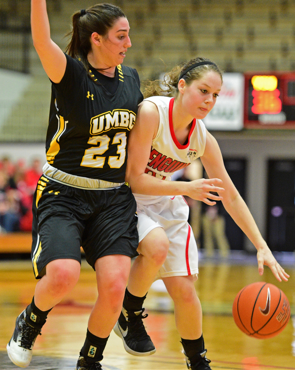 YOUNGSTOWN, OHIO - MARCH 19, 2016: Jenna Hirsch #32 of YSU dribbles tot he basket while Emily Russo #23 of UMBC guards her during the 2nd half of their game Saturday afternoon at Beeghly Center. YSU won 67-48. DAVID DERMER | THE VINDICATOR