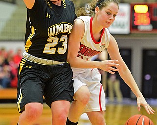 YOUNGSTOWN, OHIO - MARCH 19, 2016: Jenna Hirsch #32 of YSU dribbles tot he basket while Emily Russo #23 of UMBC guards her during the 2nd half of their game Saturday afternoon at Beeghly Center. YSU won 67-48. DAVID DERMER | THE VINDICATOR