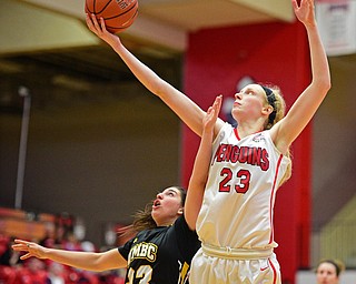YOUNGSTOWN, OHIO - MARCH 19, 2016: Sarah Cash #23 of YSU jumps above Emily Russo #23 of UMBC to grab a rebound during the 2nd half of their game Saturday afternoon at Beeghly Center. YSU won 67-48. DAVID DERMER | THE VINDICATOR
