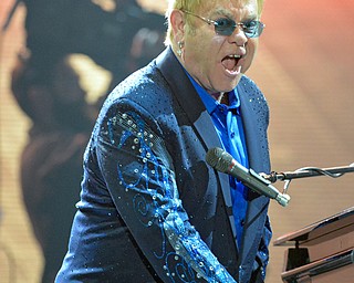 Jeff Lange | The Vindicator  TUE, MAR 22, 2016 - Elton John looks to the crowd as he performs "Bennie And The Jets" during his show Tuesday night at the Covelli Centre in Youngstown.