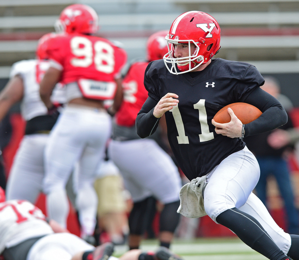 YOUNGSTOWN, OHIO - MARCH 23, 2016: Trent Hosick #11 of YSU runs the football to the outside after keeping it during the teams practice Wednesday afternoon at Stambaugh Stadium. DAVID DERMER | THE VINDICATOR