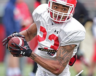 YOUNGSTOWN, OHIO - MARCH 23, 2016: Sidney Sandidge (white) turns up field to run with the football after catching a swing pass out of the backfield during the teams practice Wednesday afternoon at Stambaugh Stadium. DAVID DERMER | THE VINDICATOR..