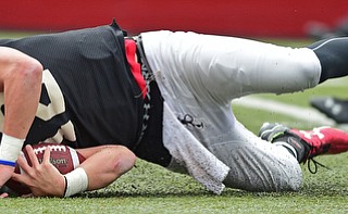 YOUNGSTOWN, OHIO - MARCH 23, 2016: Ricky Davis #12 of YSU slides across the turf after falling forward for a first down on a quarterback run during the teams practice Wednesday afternoon at Stambaugh Stadium. DAVID DERMER | THE VINDICATOR