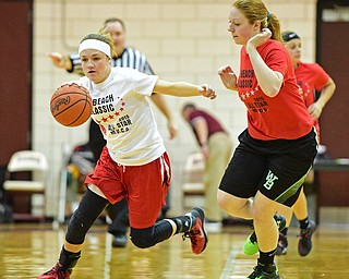 BOARD MAN, OHIO - MARCH 23, 2016: Emily Smock (white) of Jefferson dribbles up court while being pressured by Catie Hahn (red) of West Branch during the Al Beach Classic Girls All-Star Basketball game Wednesday night at Boardman High School. DAVID DERMER | THE VINDICATOR