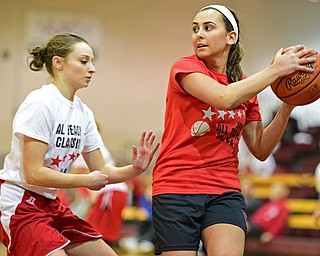 BOARD MAN, OHIO - MARCH 23, 2016: Ashley Kaleel (red) of Canfield looks to pass the ball while being pressured by Elise Hammond (white) of Columbiana during the Al Beach Classic Girls All-Star Basketball game Wednesday night at Boardman High School. DAVID DERMER | THE VINDICATOR