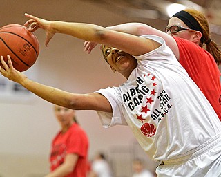 BOARD MAN, OHIO - MARCH 23, 2016: Shymara Dykes (white) of Warren Harding grabs the rebound away from Maggie Monahan (red) of Mooney during the Al Beach Classic Girls All-Star Basketball game Wednesday night at Boardman High School. DAVID DERMER | THE VINDICATOR