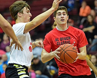 BOARD MAN, OHIO - MARCH 23, 2016: Mason Mangapora (red) of Canfield goes to the basket while being pressured by Alex Jones (white) of during the Al Beach Classic Boys All-Star Basketball game Wednesday night at Boardman High School. DAVID DERMER | THE VINDICATOR