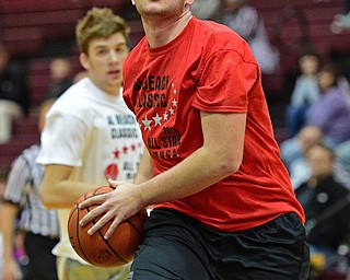 BOARD MAN, OHIO - MARCH 23, 2016: Josh Craig (red) of Lisbon goes to the basket after getting around a Trumbull County defender during the Al Beach Classic Boys All-Star Basketball game Wednesday night at Boardman High School. DAVID DERMER | THE VINDICATOR