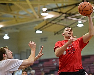 BOARD MAN, OHIO - MARCH 23, 2016: Josh Craig (red) of Lisbon goes to the basket after beating Tommy Hall of Southington (white) of Southington to the basket during the Al Beach Classic Boys All-Star Basketball game Wednesday night at Boardman High School. DAVID DERMER | THE VINDICATOR
