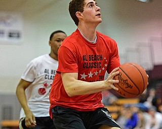 BOARD MAN, OHIO - MARCH 23, 2016: Mason Mangapora (red) of Canfield goes to the basket after beating a Trumbull Country defender to the basket during the Al Beach Classic Boys All-Star Basketball game Wednesday night at Boardman High School. DAVID DERMER | THE VINDICATOR