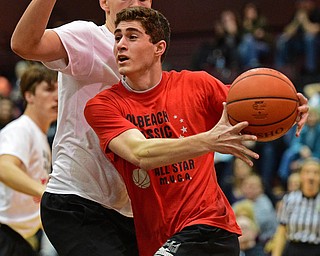 BOARD MAN, OHIO - MARCH 23, 2016: Mason Mangapora (red) of Canfield goes to the basket while being pressured by Nick Rusyn (white) of Salem during the Al Beach Classic Boys All-Star Basketball game Wednesday night at Boardman High School. DAVID DERMER | THE VINDICATOR
