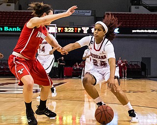 Advertiser photo by Buddy Delahoussaye--Ragin' Cajuns guard Keke Veal (24) dibbles pass the Penguins defense on Wednesday night in the Cajun Dome.