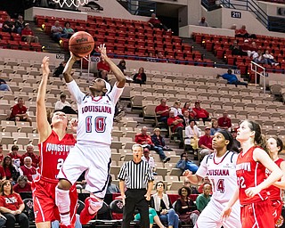 Advertiser photo by Buddy Delahoussaye--Ragin' Cajuns guard Kia Wilridge (10) takes it to the hole on Wednesday night in the Cajun Dome.